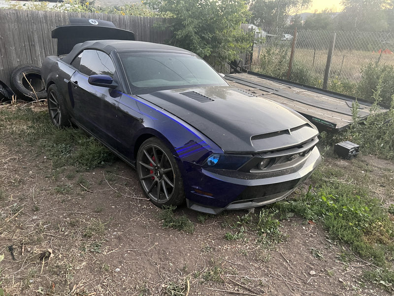 Dark blue Ford Mustang convertible with blue accent lighting