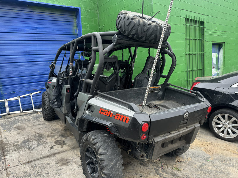 Can-Am side-by-side with a roll cage and spare tire
